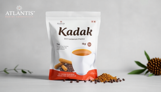 Kadak 3in1 Cardamom Tea Premix for Offices packaged in a white and orange 1kg pouch with tea granules and cardamom seeds