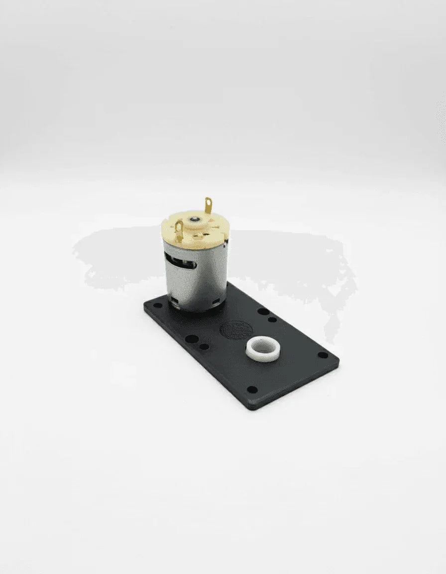 Small motor mounted on a black plastic base showing product detail for Amazon tea premix Noida