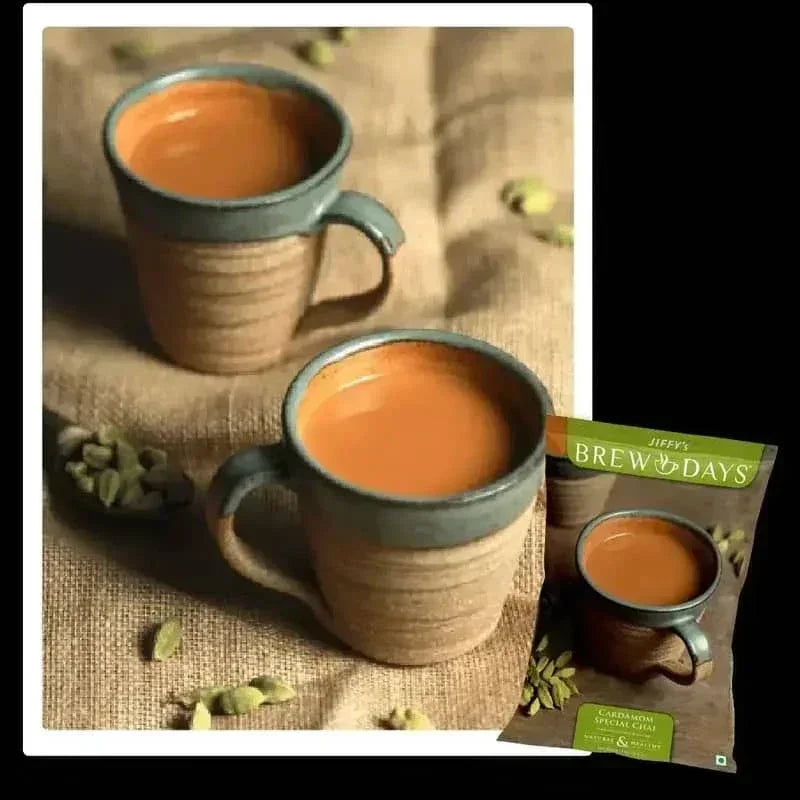 Two cups of hot brewed cardamom tea with cardamom pods and cardamom tea premix for offices packet