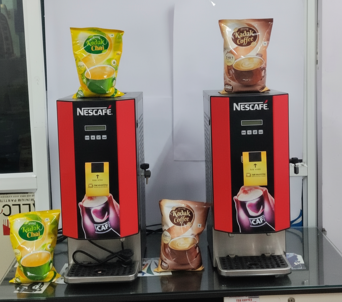 Two Nescafe coffee and tea vending machines with Kadak Coffee and Kadak Chai packets on a black table Amazon tea coffee machine Noida