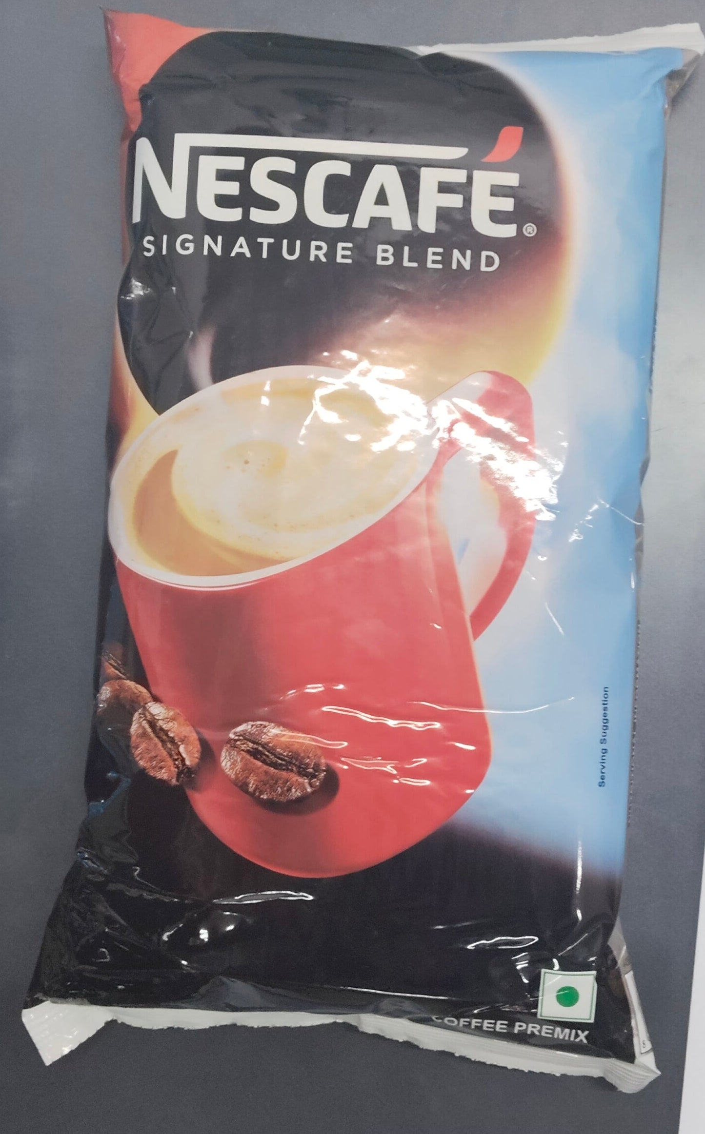 Nescafe Signature Blend 1kg premix coffee pack featuring a red cup with coffee and coffee beans