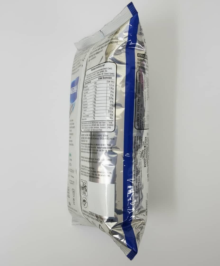 Side view of Nestea Masala Gold instant tea premix silver and blue packaging with nutrition facts