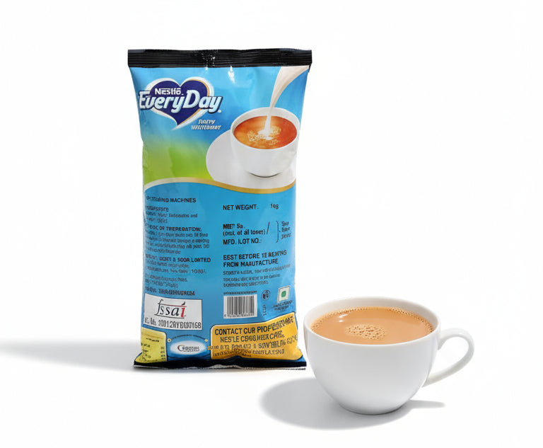 Nestle Everyday dairy whitener 1kg pack beside a white cup of tea with milk