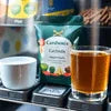 Coffee vending machine with milk cup, sugar packet, and glass of coffee premix