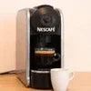 Nescafe 8 option coffee machine black countertop model with white coffee cup