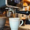 Espresso machine brewing coffee into white cup best coffee machine for office use