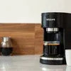 NESCAFE coffee machine supplier Noida black coffee maker on kitchen counter with glass carafe