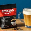 Amazon coffee premix pack beside a glass of layered coffee latte showing where to buy coffee premix for offices