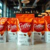Coffee packets arranged in rows showcasing product variety for office coffee machine service in Delhi