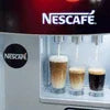 Nescafe coffee vending machine price showing three cups of coffee being dispensed