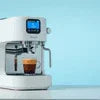 Atlantis Coffee Machine Neo 2 Lane review showing white coffee machine brewing espresso