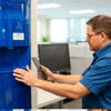 Technician performing best water dispenser maintenance in Noida on office water cooler