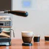 Espresso coffee machine brewing alongside cups on wooden counter coffee machine rental Noida Sector 16