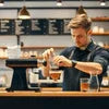 Barista preparing coffee using Nescafe premix supplier in Chandigarh product at café counter