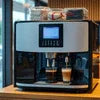Atlantis coffee machine rental Delhi black and silver automatic espresso maker in cafe setting