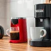 Nescafe coffee machine vs traditional coffee maker with red Nescafe machine and black traditional coffee maker brewing coffee