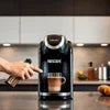 Nescafe coffee machine cleaning guide showing hands cleaning a Nescafe coffee machine in a kitchen