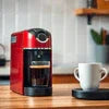 Nescafe coffee machine price in Delhi red model on wooden table with white cup