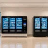 Atlantis 4 lane coffee machine price displayed on vending coffee machines in a modern lobby