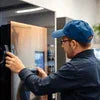 Technician performing maintenance on coffee vending machine showing how to maintain coffee vending machines
