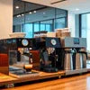 Coffee machine rental Gurgaon showing modern espresso machines on a wooden counter in a cafe