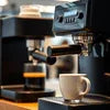 Breville espresso machine brewing coffee into a white cup best coffee machines in Delhi 2025