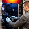 Man performing tea coffee machine maintenance tips for office on a commercial vending machine
