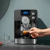 Person operating a Nescafe UPI coffee machine Delhi brewing fresh espresso in a modern kitchen setting