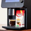 Close-up of a coffee machine brewing coffee with a coffee jar, featuring the best office coffee machines in Delhi 2025