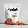 Kadak cardamom tea premix for offices pack with a cup of tea and cardamom pods