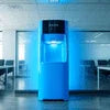 Atlantis Blue S water dispenser Delhi model in office setting with blue ambient lighting