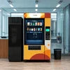 Modern coffee machine with touchscreen interface and multiple beverage options in office setting