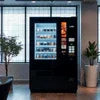 Coffee vending machine supplier in Noida black vending machine with multiple coffee options in office setting