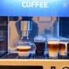 Nescafe Coffee Machine price displayed with freshly brewed coffee cups under machine dispenser