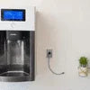 Atlantis Big Plus 5 Ltr RO Kit Water Dispenser mounted on wall with digital display and water tap