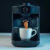 Black coffee machine brewing espresso with white cup on drip tray Coffee MACHINE RENTAL GRETER NOIDA