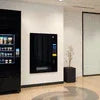 Atlantis Coffee Vending Machine Greater Noida sleek black wall-mounted coffee dispenser in modern office lobby