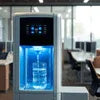 Hot and Cold Water Dispenser Noida in office setting with blue-lit water bottle