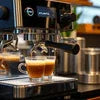 Atlantis Coffee Machine 4 Lane AMAZONE ONLINE brewing espresso with two shots in a coffee shop