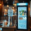 4-Lane Vending Machine stocked with beverages and snacks in a cafe setting