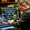 Technician performing coffee machine service near me on commercial espresso machine