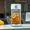 Atlantis tea coffee machine Noida brewing orange infused tea in white modern kitchen