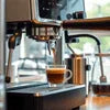 Atlantis coffee machine Noida espresso shot brewing with steam wand and cup on drip tray