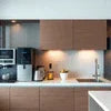 Atlantis office coffee machine Noida countertop model in modern kitchen setup with wooden cabinets