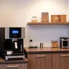 Atlantis coffee machine on kitchen counter with shelves and kitchen appliances