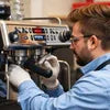 Technician repairing espresso coffee machine showing best coffee machine repair experts near me service
