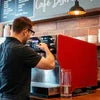 Coffee vending machine being used by a man in an office cafe setting best coffee vending machines for offices Delhi