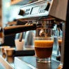 Modern tea coffee vending machine Sector 18 Noida brewing fresh coffee in a glass cup