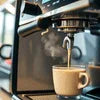 Tea and coffee vending machine installation service with espresso pouring fresh coffee cup
