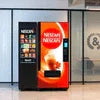 Nescafe coffee vending machine supplier Noida branded machine dispensing hot coffee in office lobby
